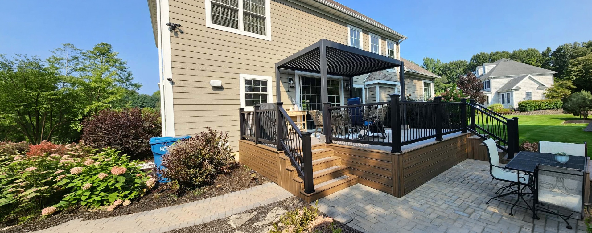 Spacious composite deck with railing overlooking a wooded backyard in Southwest Michigan